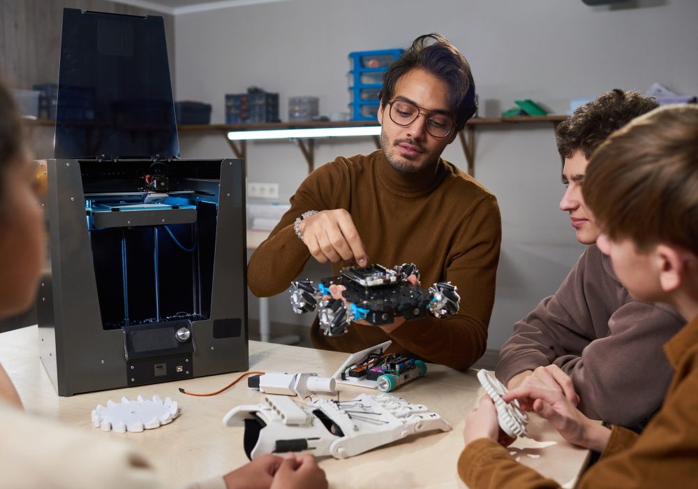 Teacher building a robotic machine at science school
